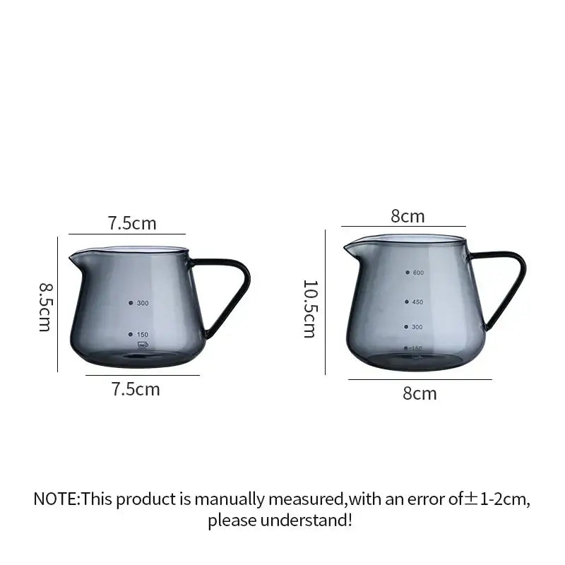Two dark gray glass coffee pots with black handles and clear measurement markings for precise kitchen use
