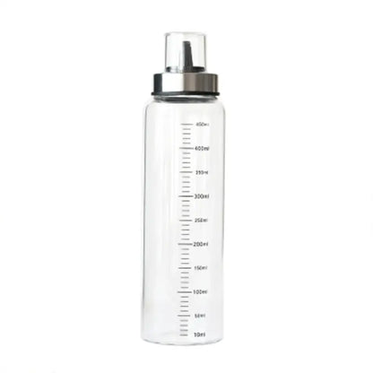Clear plastic water bottle with silver metal cap and milliliter markings in a glass condiment bottle set for kitchen use