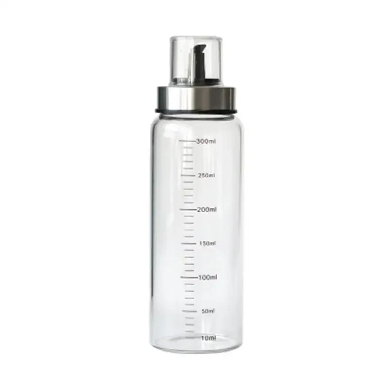 Clear glass condiment bottle with silver pump dispenser and milliliter measurements in glass condiment bottle set for kitchen use