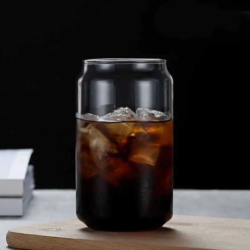 Clear glass drink cup shaped like a soda can filled with iced coffee featuring bamboo lid and straw decorbites glass drink