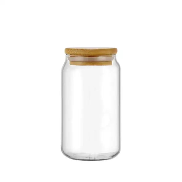 Clear glass drink cup with a natural bamboo lid and straw in a decorbites glass drink cup for kitchen soda use
