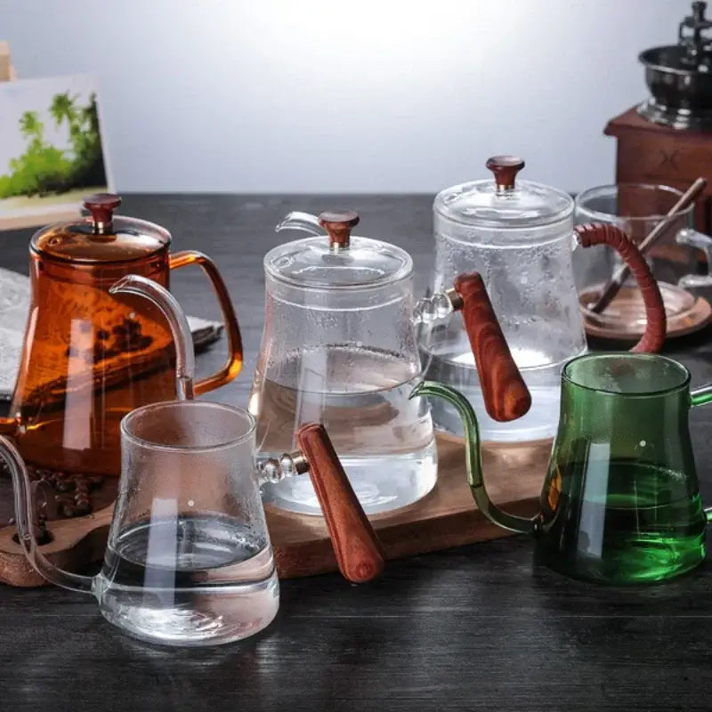 Clear glass hand drip coffee kettle with wooden handle and lid designed for brewing tea or water decorbites glass coffee