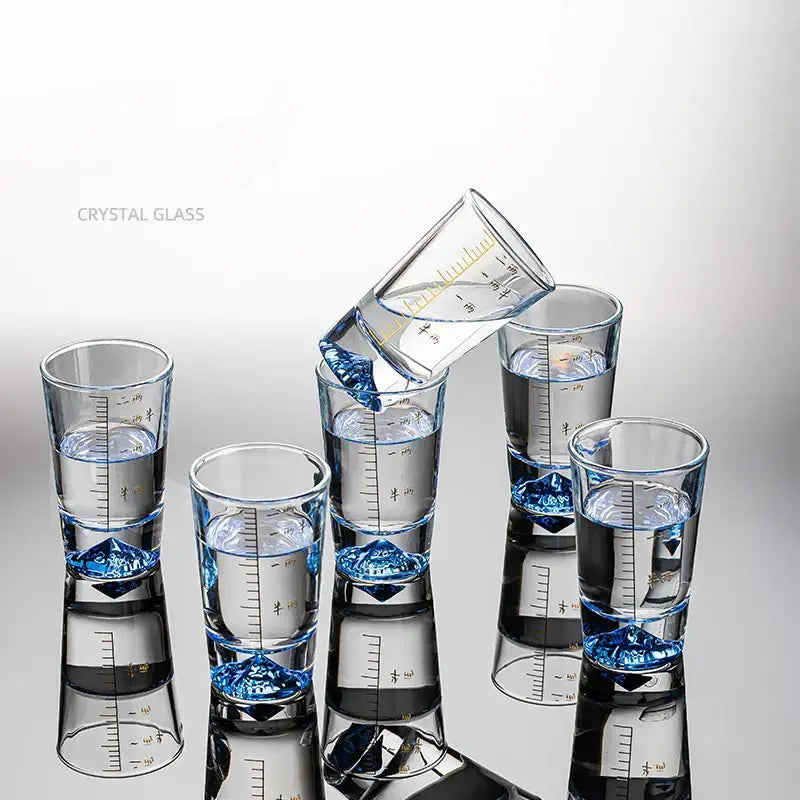 Clear glass liquor cup set with measurement markings featuring clear crystal glass and blue diamond-shaped bases decorbites clear glass