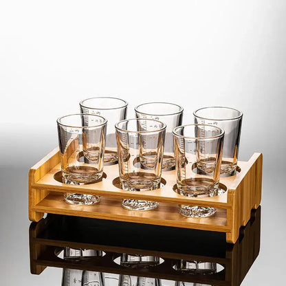 Set of six clear glass liquor cups with measurement markings in a light wood serving tray for decorbites clear glass dining room use