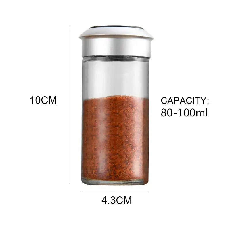 Clear glass rotating spice jar with silver lid filled with reddish-brown seasoning for decorbites rotating spice set