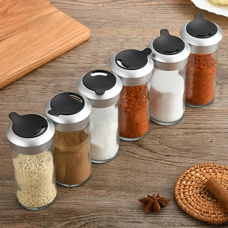 Set of five clear glass rotating spice jars with silver lids and black flip-top caps for spice jar seasoning decorbites rotating spice