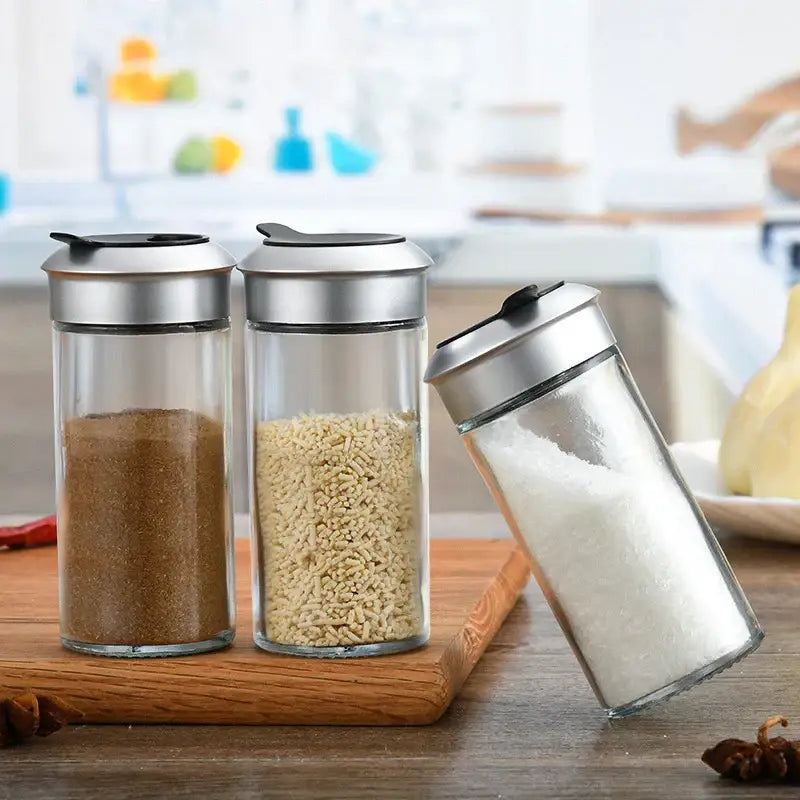 Set of three clear glass rotating spice jars with silver metal lids for spice jar seasoning by decorbites rotating spice