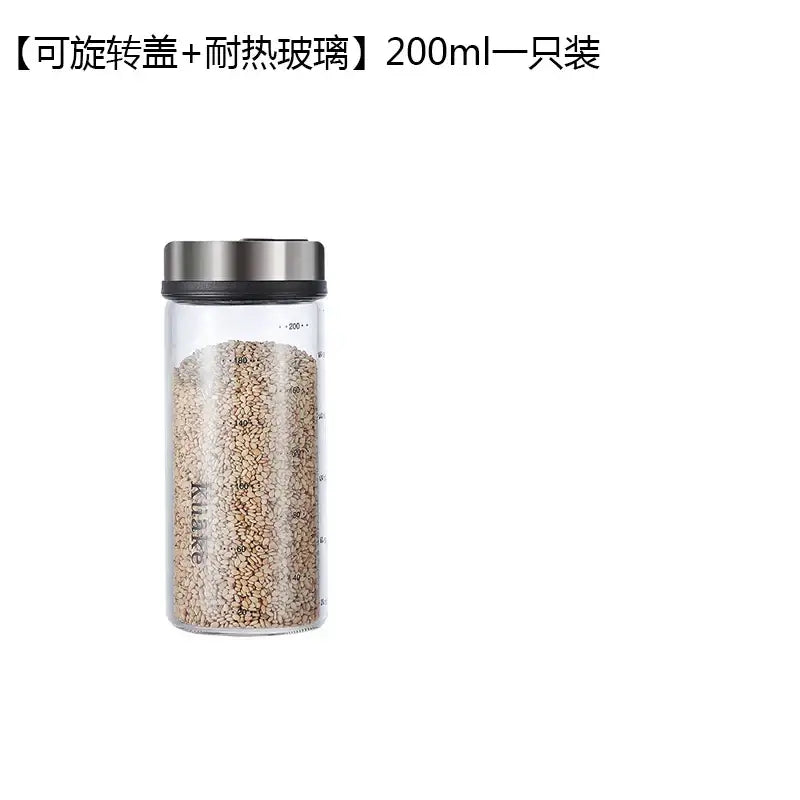 Clear glass spice shaker with silver rotary lid 200ml capacity filled with light brown sesame seeds for kitchen storage