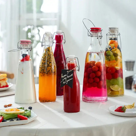 Clear glass storage bottle with swing top lid from decorbites glass storage filled with colorful fruit-infused liquids