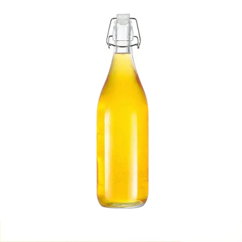 Clear glass storage bottle with swing top lid filled with golden liquid decorbites glass storage for kitchen use