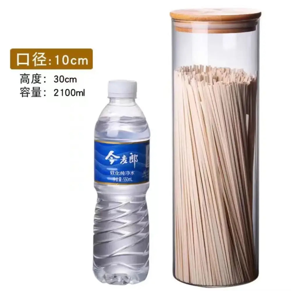 Transparent glass storage jar with bamboo lid filled with dried noodles for kitchen organization in glass storage jars