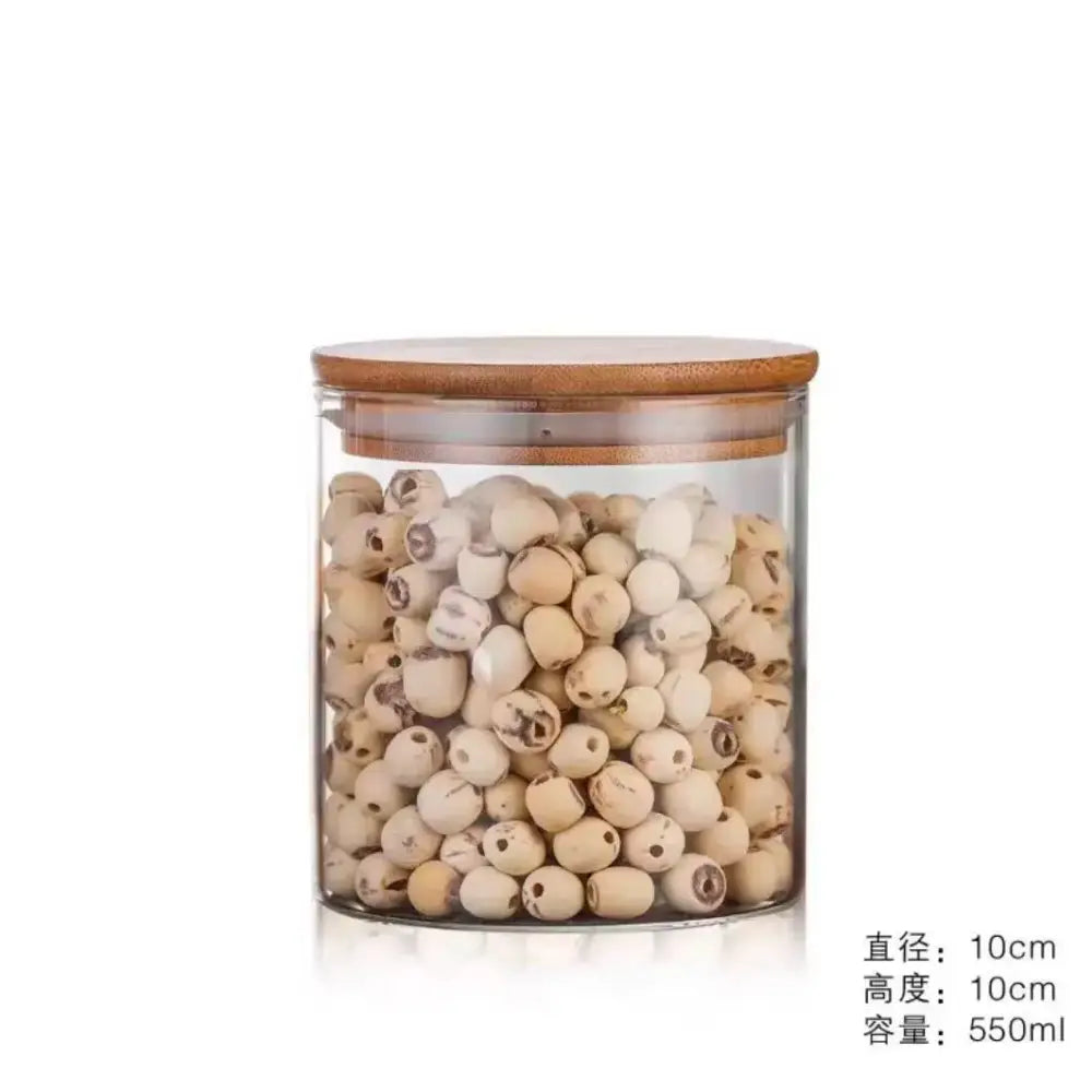 Clear glass storage jar with bamboo lid filled with light beige lotus seeds for kitchen organization
