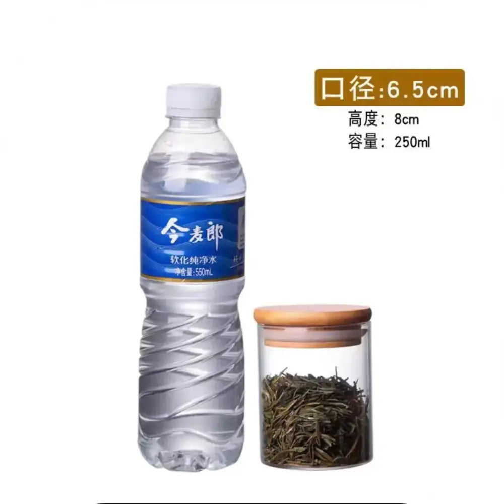 Clear plastic bottle with white cap and blue label next to clear glass storage jars with bamboo lids for kitchen organization