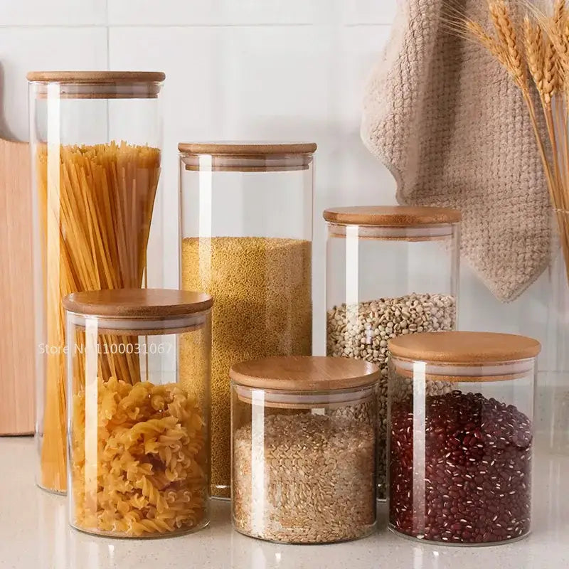Clear glass storage jars with bamboo lids for kitchen organization holding pasta and grains for glass storage