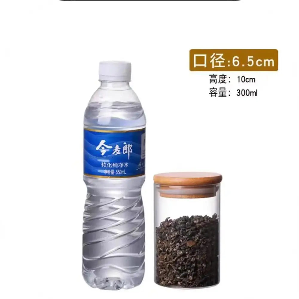 Clear plastic water bottle with blue label next to clear glass storage jars with bamboo lids for kitchen organization