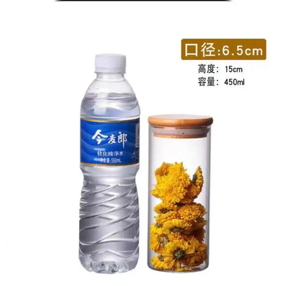 Transparent glass storage jar with bamboo lid filled with yellow dried flowers for kitchen storage jars organization
