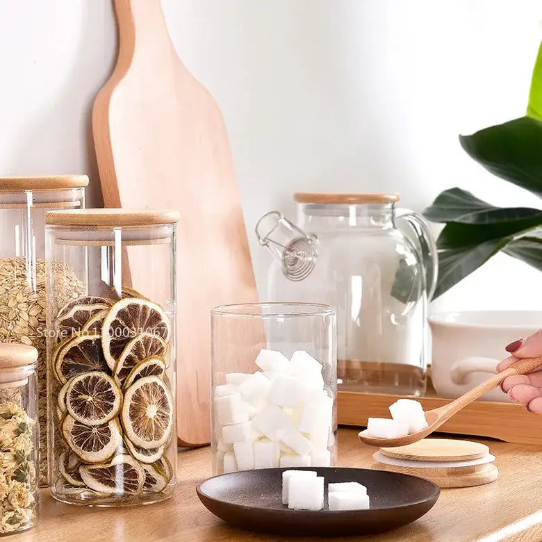 Clear glass storage jar with bamboo lid filled with dried citrus slices for kitchen organization and glass storage