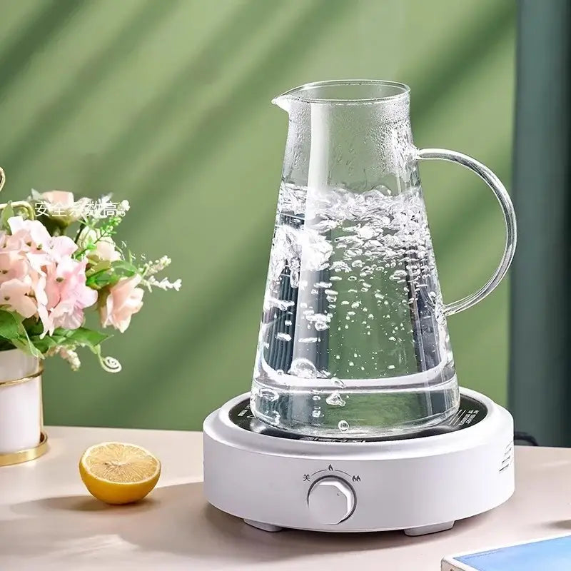 Clear glass juice kettle from decorbites kettle set with handle on white electric heating base for kitchen beverage use
