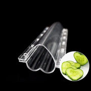 Clear plastic heart shaped vegetable growth mold with ridged interior and circular cutouts for kitchen vegetable growth