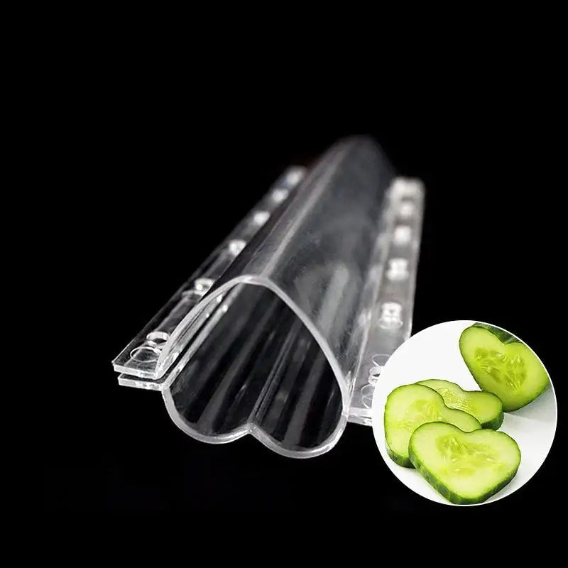 Clear plastic heart shaped vegetable growth mold with ridged interior and circular cutouts for kitchen vegetable growth