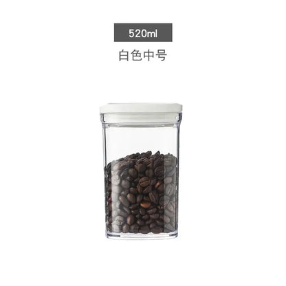 Clear rectangular glass decorbites hermetic kitchen organizer with white lid holding dark roasted coffee beans