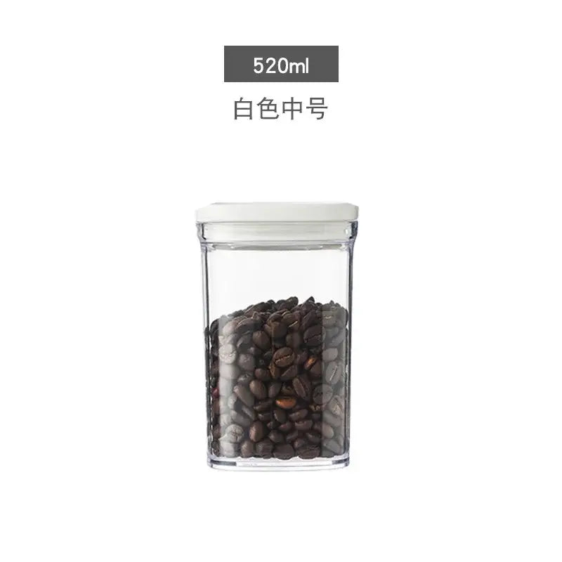 Clear rectangular glass decorbites hermetic kitchen organizer with white lid holding dark roasted coffee beans