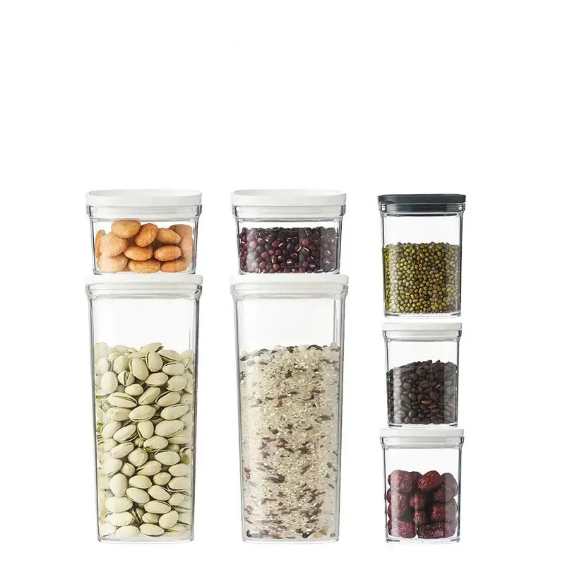 Clear hermetic kitchen organizer by decorbites featuring clear rectangular food containers with white and black lids storing dried legumes and nuts