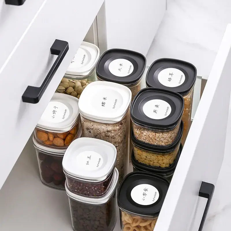 Clear hermetic kitchen organizer featuring clear plastic food storage containers with black and white lids labeled in chinese decorbites hermetic kitchen