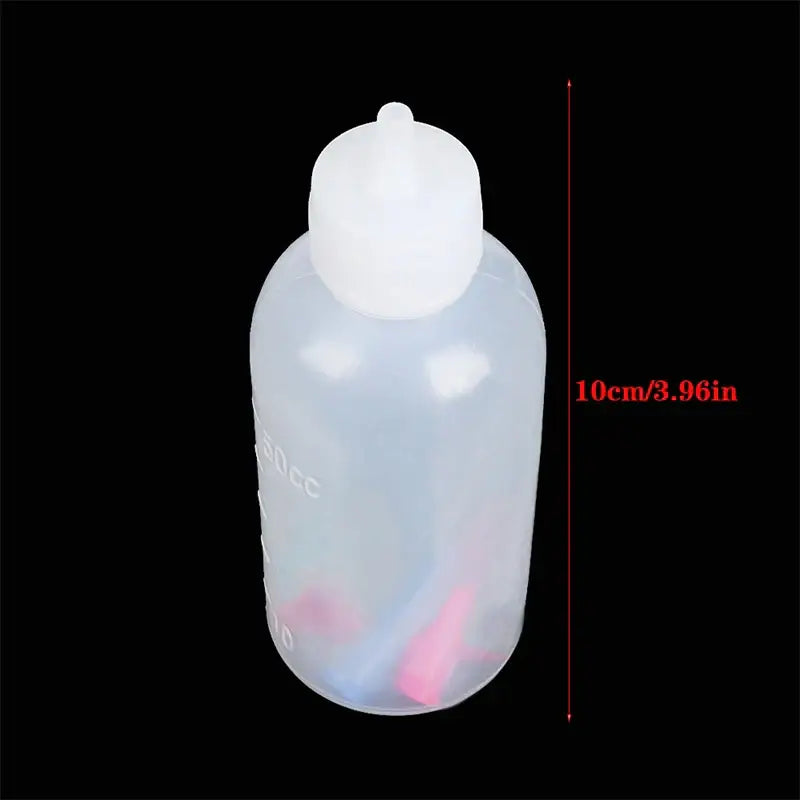 Transparent plastic squeeze bottle with white rounded cap and measurement markings for decorbites cake decor use