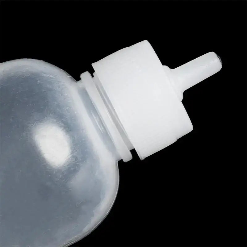 Clear plastic cake decor squeeze bottle with white tapered nozzle cap for decorbites cake decor and kitchen use