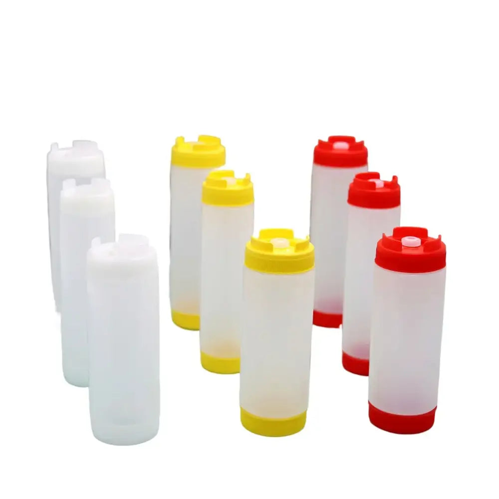Clear plastic tomato squeeze bottles with yellow and red caps in a kitchen set for tomato squeeze use