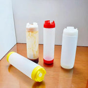 Clear plastic tomato squeeze bottles with red white and yellow caps ideal for kitchen use in a squeeze bottle set