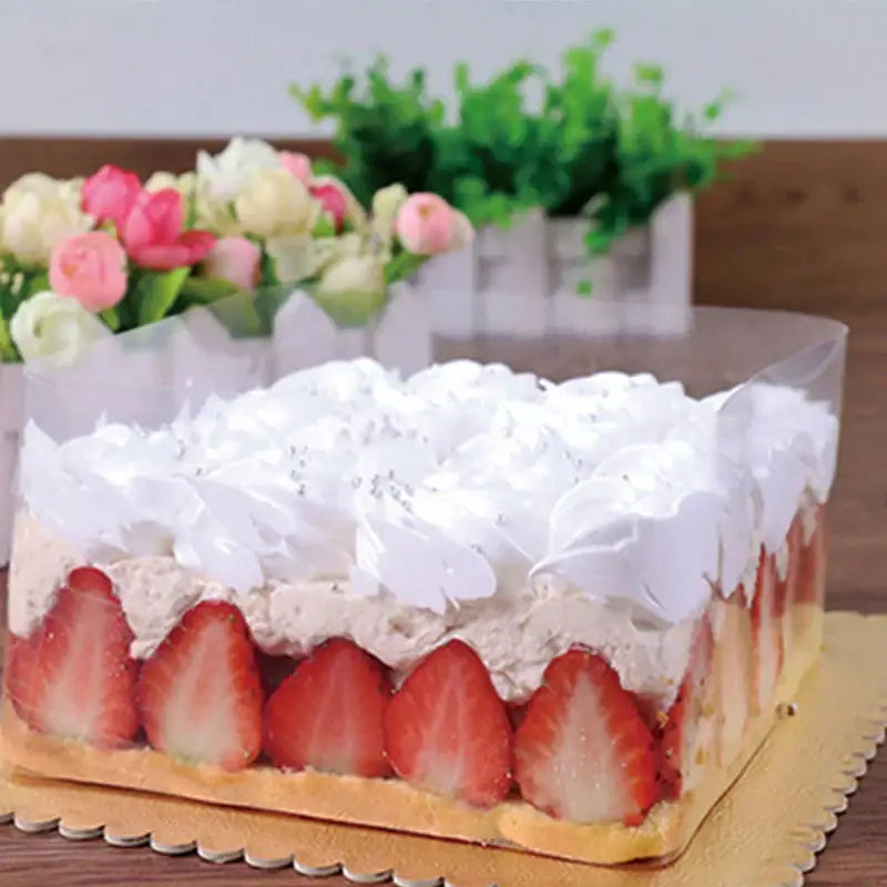Rectangular strawberry shortcake with golden crust and whipped cream wrapped in clear decorbites cake edge wrap