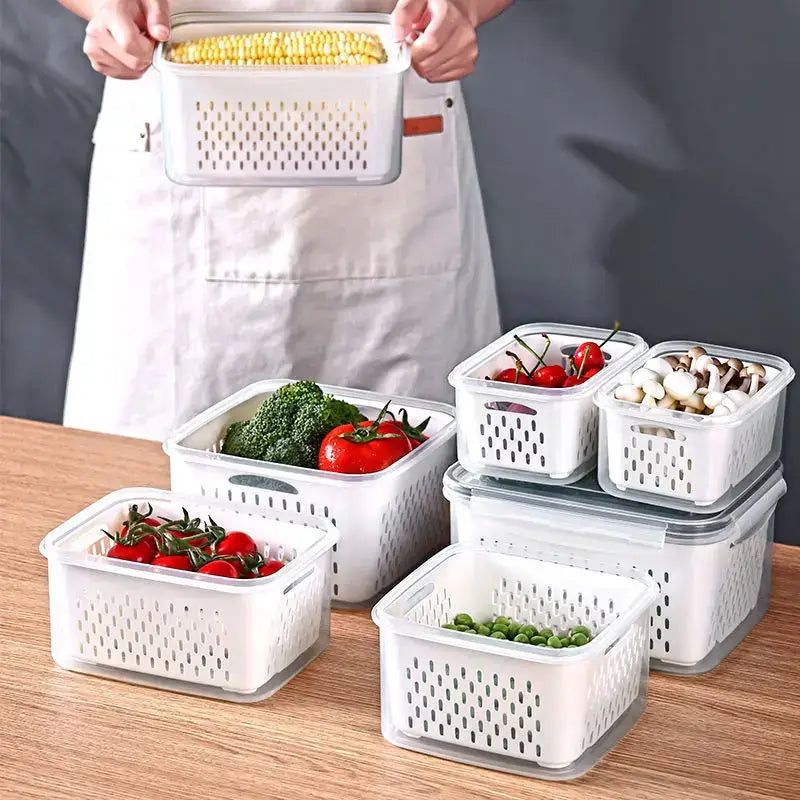 White plastic fridge storage containers with drain basket and perforated sides featuring clear lids by decorbites