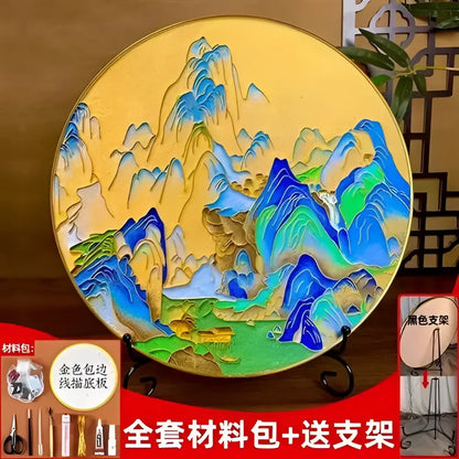 Circular decorative plate featuring layered blue and green mountain landscape with gold rim accents from decorbites cloisonne silk enamel diy kit