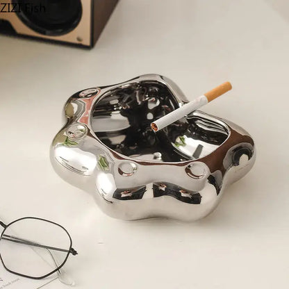 Shiny metallic ashtray with smooth reflective surface and rounded contours for cloud cat paw porcelain decorbites cat paw gift