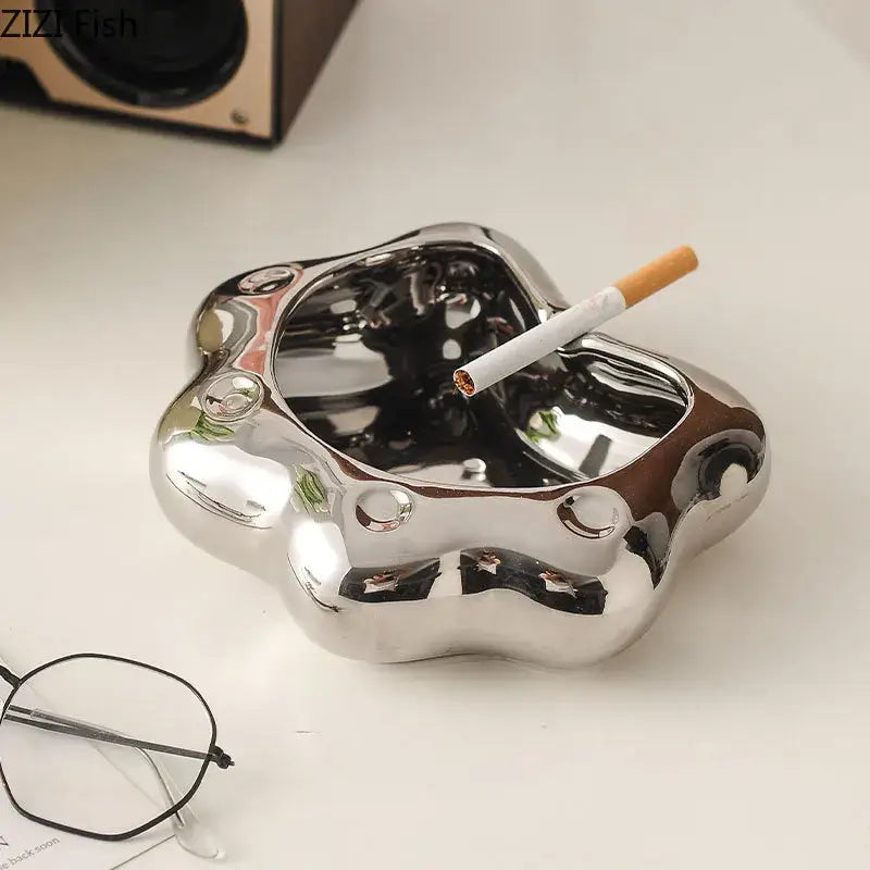 Shiny metallic ashtray with smooth reflective surface and rounded contours for cloud cat paw porcelain decorbites cat paw gift
