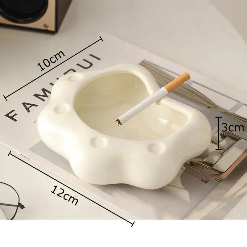 White ceramic cat paw porcelain ashtray with cloud-like rounded design and circular indentations for decorbites cat paw decor