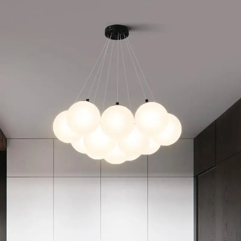 Modern cloud-shaped pendant lights with multiple frosted glass ball led spheres on black metal fixture for bedroom decorbites decor