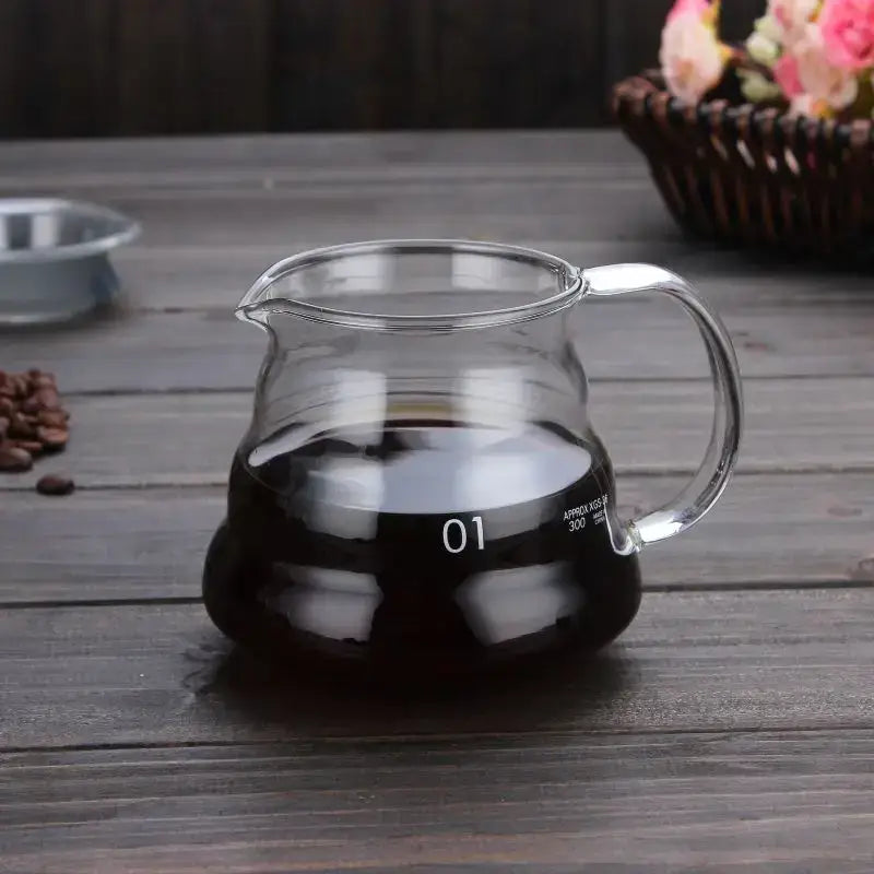Clear glass coffee kettle with silver handle filled with dark brewed coffee decorbites cloud glass coffee pot