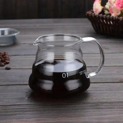 Clear glass coffee kettle with silver handle filled with dark brewed coffee decorbites cloud glass coffee pot