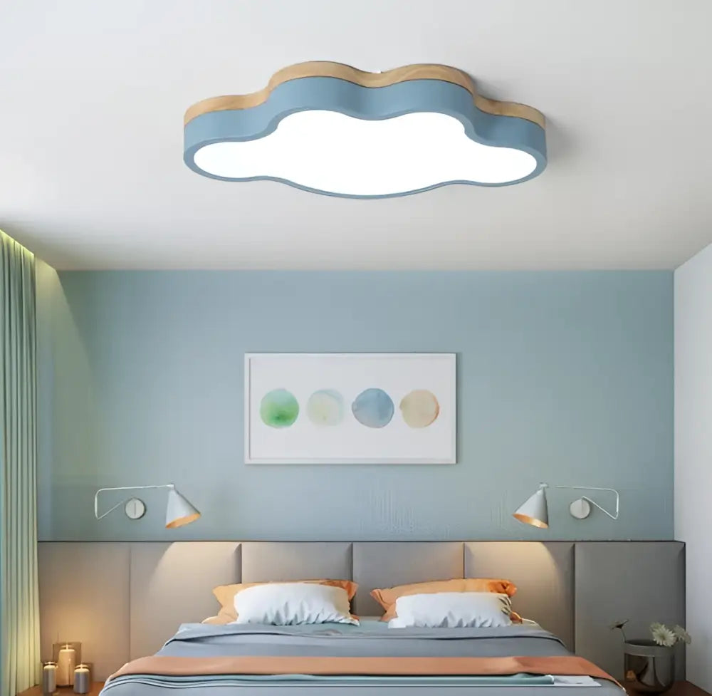 Cloud led baby chandelier with soft blue body, wooden trim, and bright white illumination for sage green and pink decorbites room