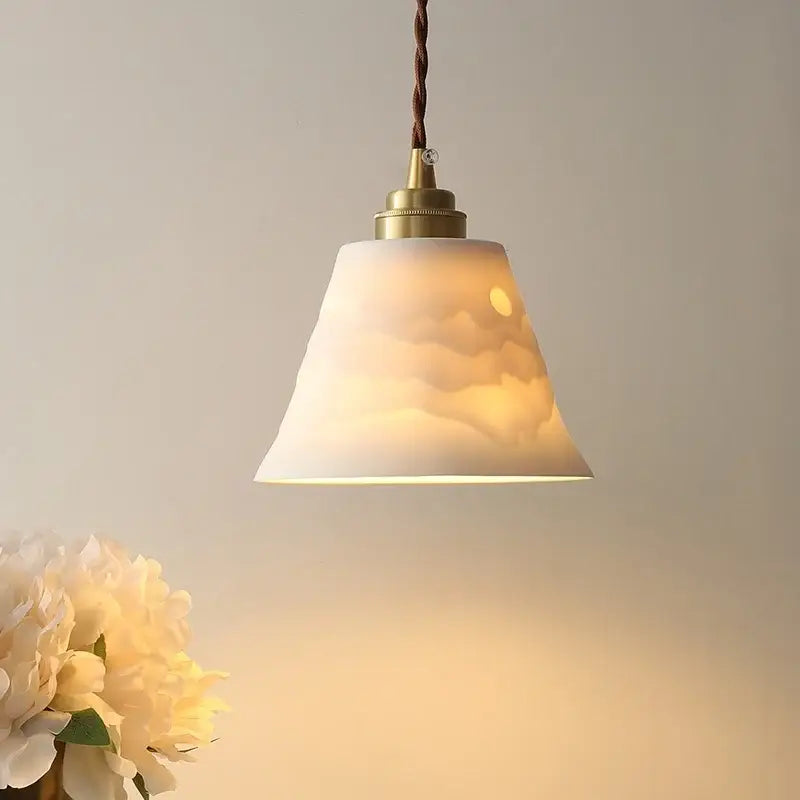 Warm-toned translucent brass ceramic led pendant light with cloud and moon design by decorbites for dining room decor