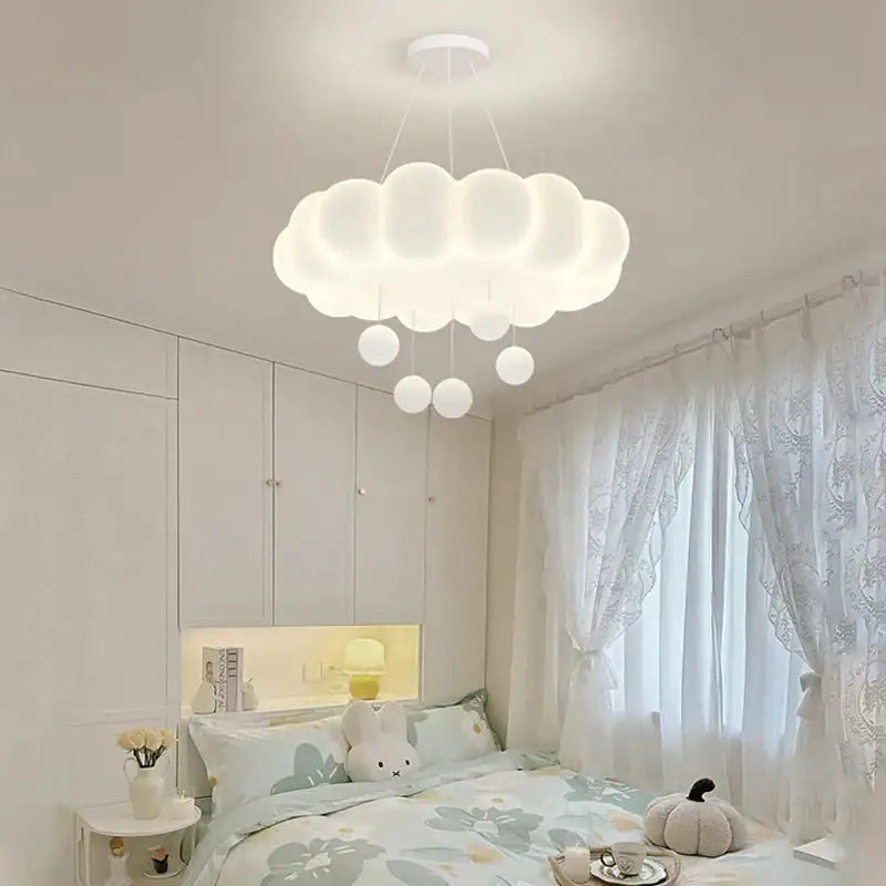 A soft white cloud shaped off white pendant light with dangling spherical bulbs from decorbites dimming pendant collection