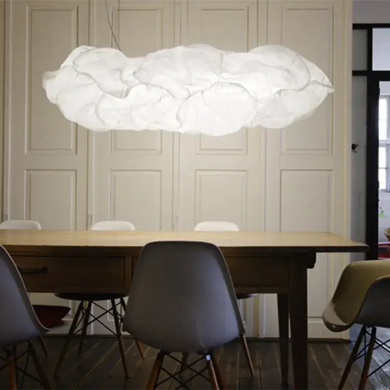 A cloud white pendant light with textured organic rice paper hangs above the dining table in a kitchen setting