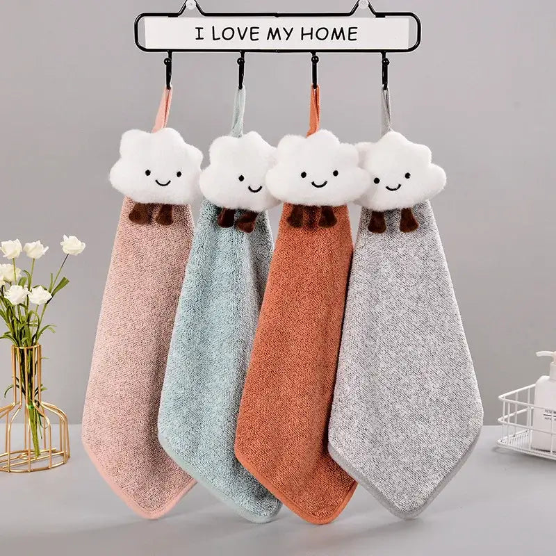 Four pastel pink mint green terracotta orange and heather gray decorbites cloudy day hand towels hang on a rack