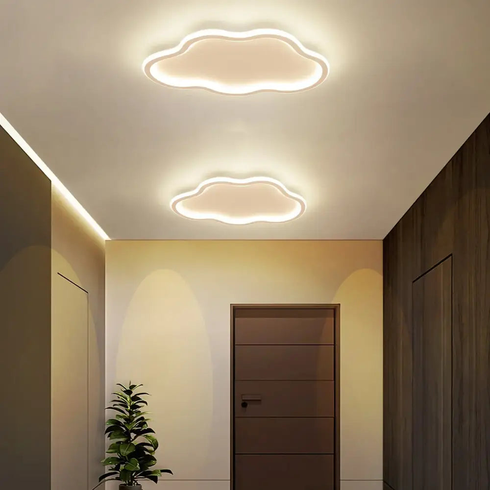 Two illuminated cloud-shaped decorbites cloudy white kids ceiling lamps with a soft white glow for creative bedroom lighting