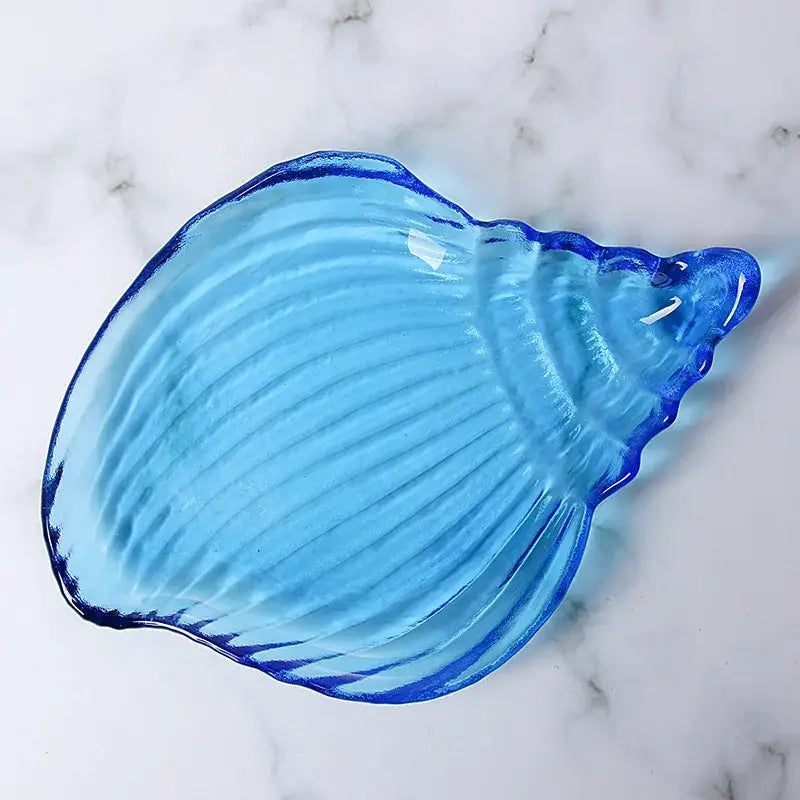 Translucent blue glass dish plate saucer shaped like a ribbed seashell for coastal dining room or snack set
