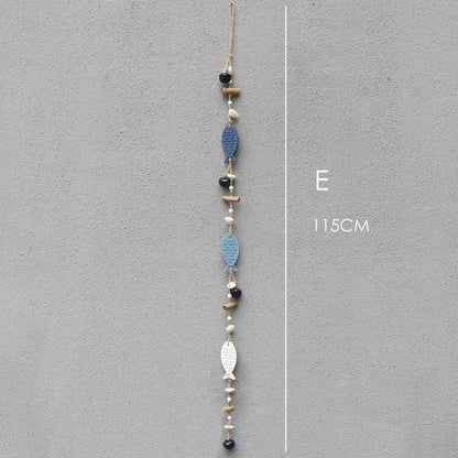 A 115cm coastal blue and white fish drift wood bells hanging chain with wood bells and black beads on twine for wall decor
