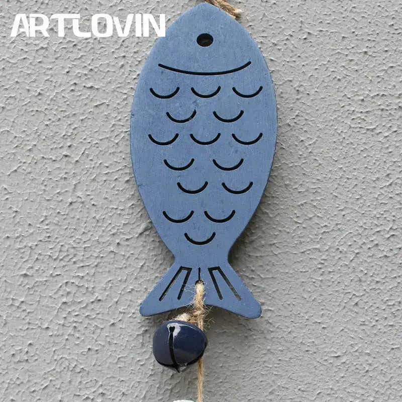 Coastal blue and white drift wood bells featuring a blue wooden fish with black engraved scales and a dark blue bell